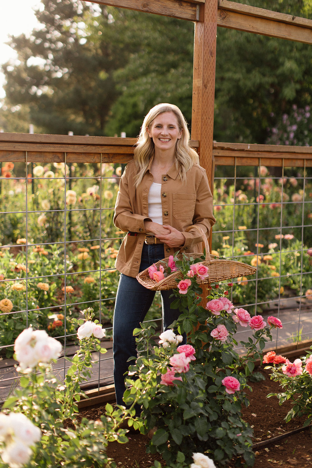 Christine Clair, founder of Cloverdale, standing among dahlias